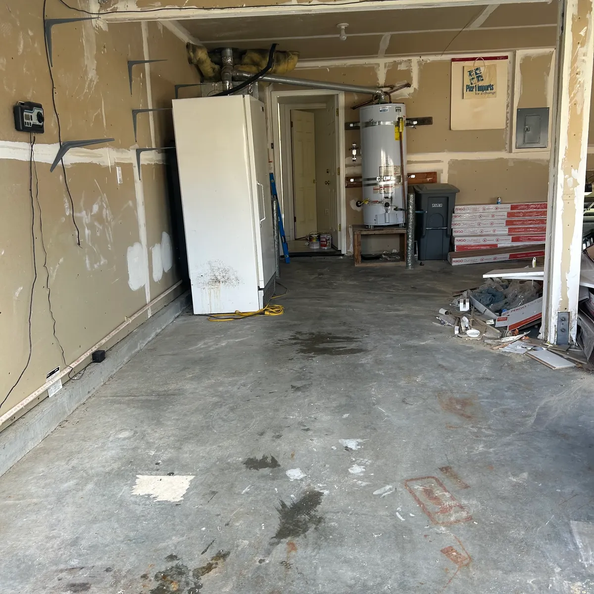 Same garage cleared to open concrete floor after carpet removal