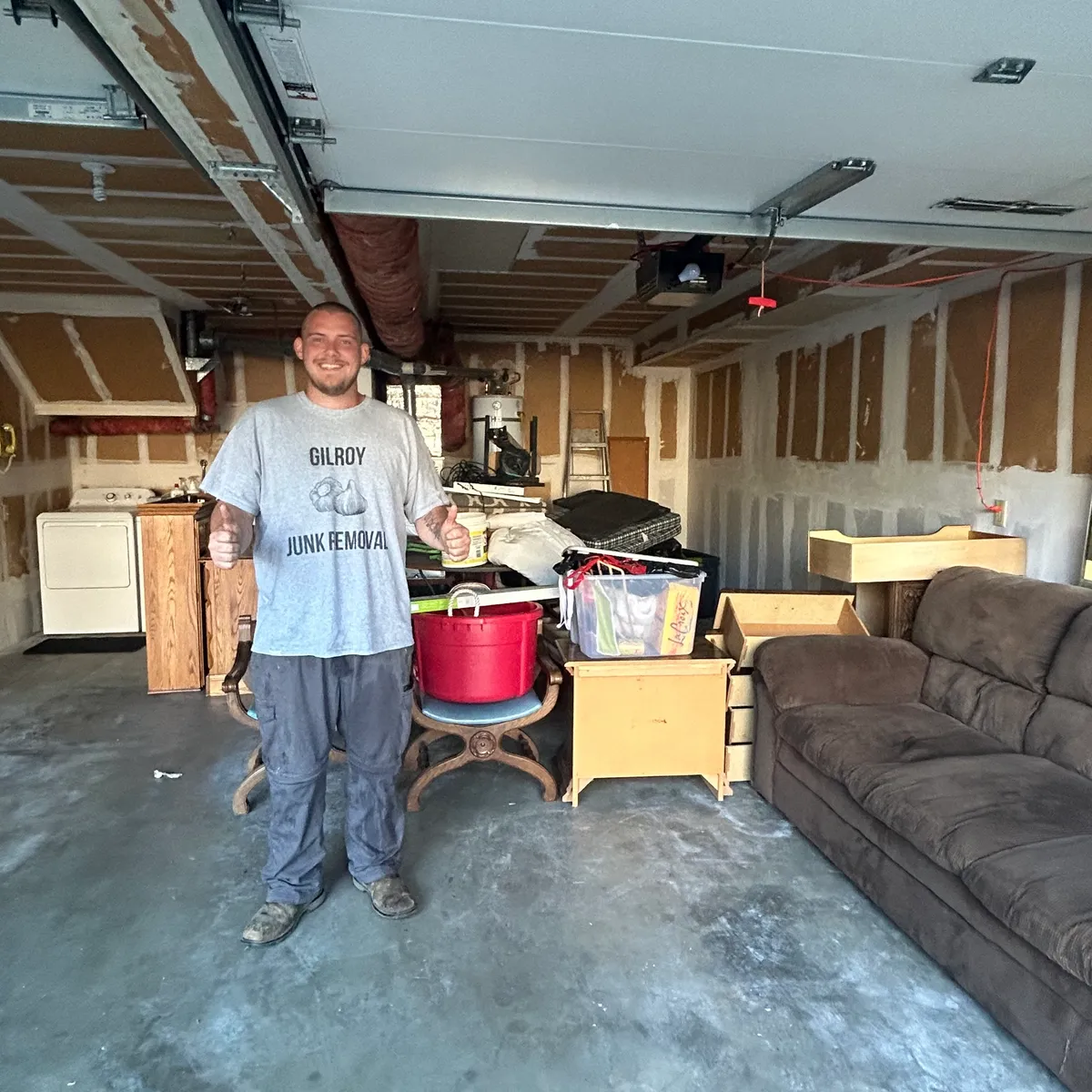 Gilroy garage packed with a sofa, dresser, and appliances before junk removal